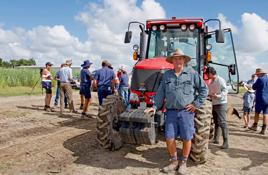 Mackay district cane farmer and harvest contractor, Steve Young, with one of the tractors fitted with Hitachi's QZSS receiver technology and HPI intelligence to trial satellite-guided autonomous farming in his fields and at a demonstration day.