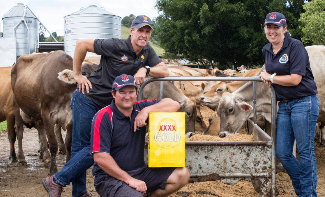 Lion suppliers, Ray and Catherine De Vere, who farm west of Nambour on Queensland's Sunshine Coast, with their cows sampling brewers' grain from Lion's XXXX brewery, and Lion farm services officer, Cameron Whitson, poised to shout everybody a beer.