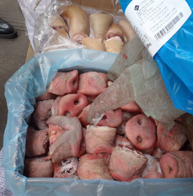 Pig snouts and trotters on sale in an open air wet market in Chengdu.