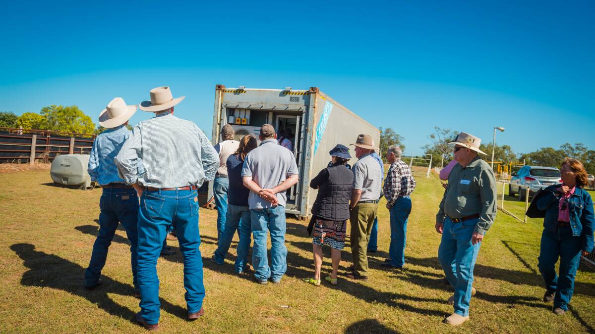 Cattle producers line up to check out how a DEXA unit works at a Queensland field day explaining the technology recently.