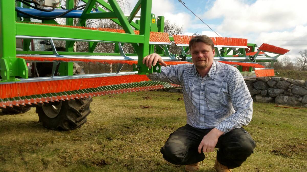 Inventor Jonas Carlsson with his CombCut machine designed to control weeds in organic farming systems.
