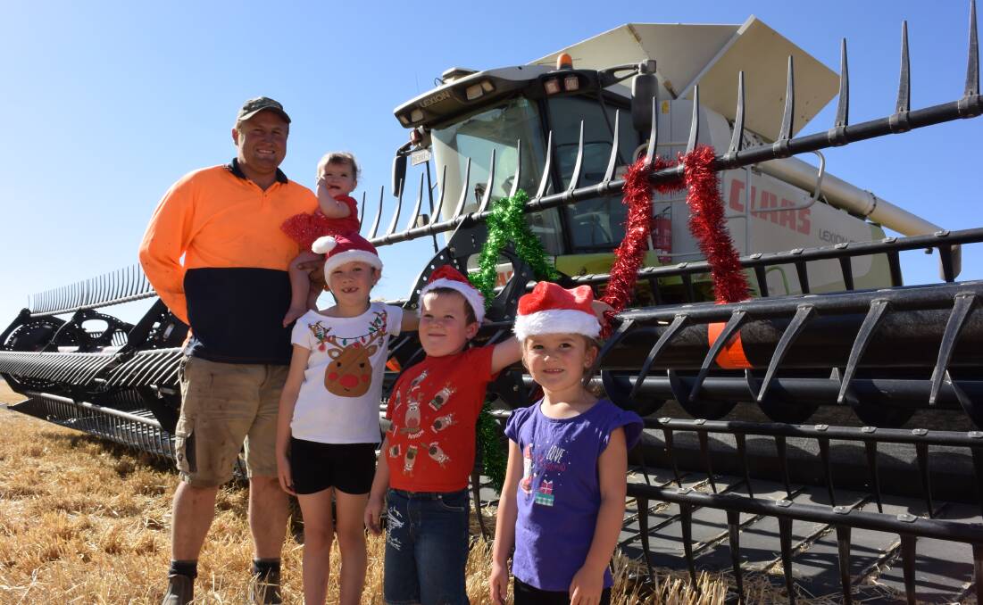 Dale Hateley and his children Isabel (being held) Chloe, Riley and Tahlia, take the Christmas spirit out to the family’s block at Cooack, north of Mitre last week.