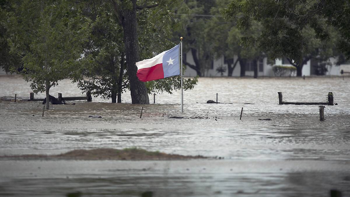 A lonely Texas flag rises above rampant floodwaters during Hurricane Harvey.