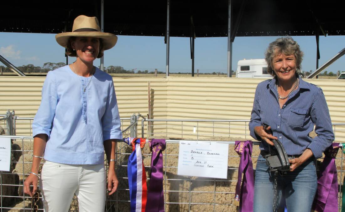 Ali Krieg, the owner of the grand champion pen of flock ewes at the Blackall show, was presented with her dog trap prize by Blackall flock ewe show steward, Megan Mohr.