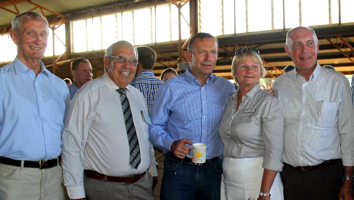 Flashback: Diamantina and Barcoo shire mayors Geoff Morton and Julie Groves posing for a photo with then-Prime Minister Tony Abbott at Longreach in May, when they shook hands on a deal to deliver fibre optic cable to their communities, that later became complicated by politics. Watching on were Member for Maranoa Bruce Scott and deputy Prime Minister Warren Truss. Picture: Sally Cripps.