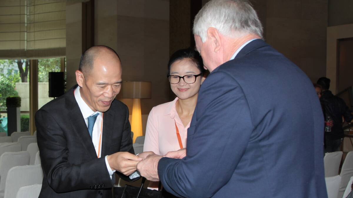 Hangzhou Chamber of Commerce general secretary Xiao Min and Toowoomba Regional Council mayor Paul Antonio exchanging business cards during Monday's MOU signing.