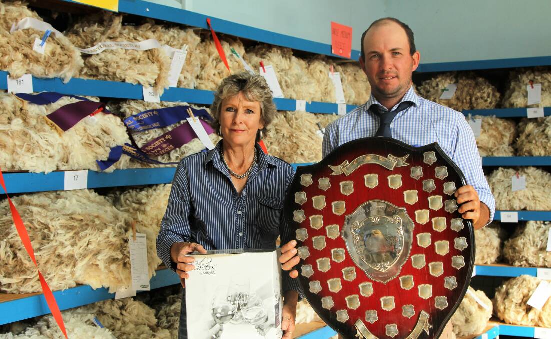 Ali Krieg receiving the Norman and Marion White Memorial aggregate shield in the wool court from Barcoo Pastoral Society president, Hugh Macdonald.