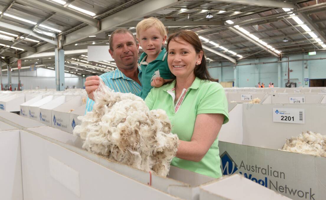 Malcolm and Jodie Healey, “Box Hill", Turondale, NSW, with their son, Billy, 4, pictured during their annual trip to the Yennora wool auctions, are expecting to make a record $3000 a bale this year. 