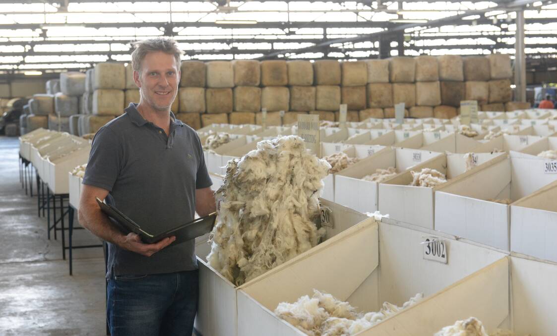 Endeavour Wool, Sydney buying manager, Stuart Greenshields, inspecting wool at Yennora wool auctions recently. 