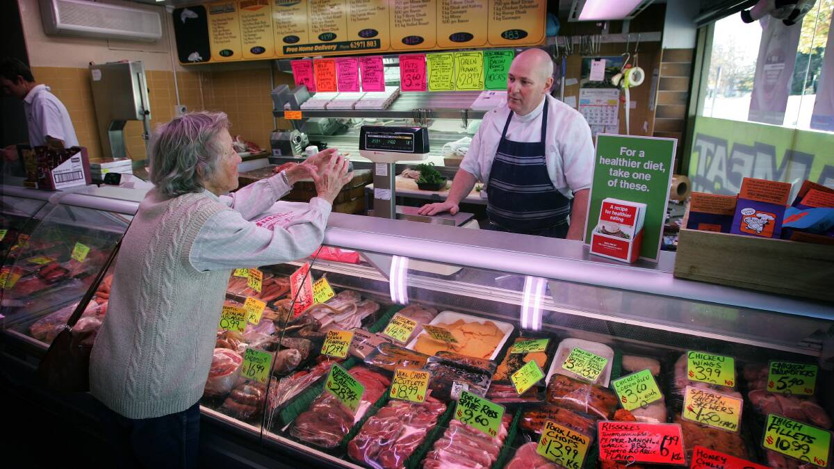 Queanbeyan Butcher Peter Lindbeck serving regular customer Ann Lund from Burra. Photo: Andrew Sheargold