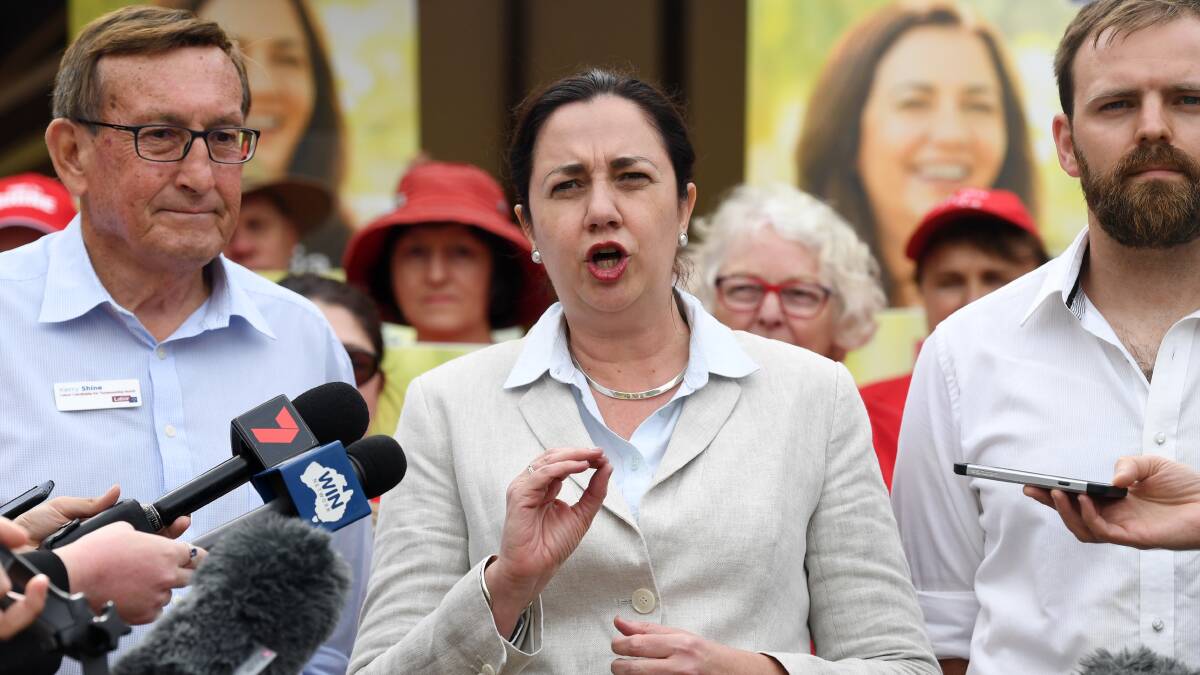 Premier Annastacia Palaszczuk (centre), the Labor candidate for Toowoomba North, Kerry Shine (left), and candidate for Condamine, Brendon Huybregts (right), are seen in a press conference in Toowoomba. Photo: AAP
