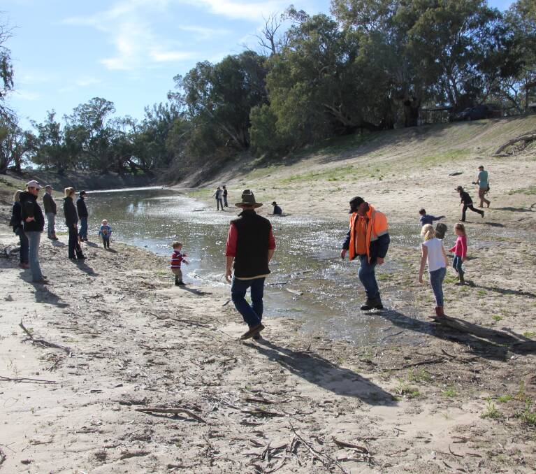 Locals gathering to celebrate the fresh flush of water into the parched river, but worries linger about quality and quantity. Photo Nerida Healy.