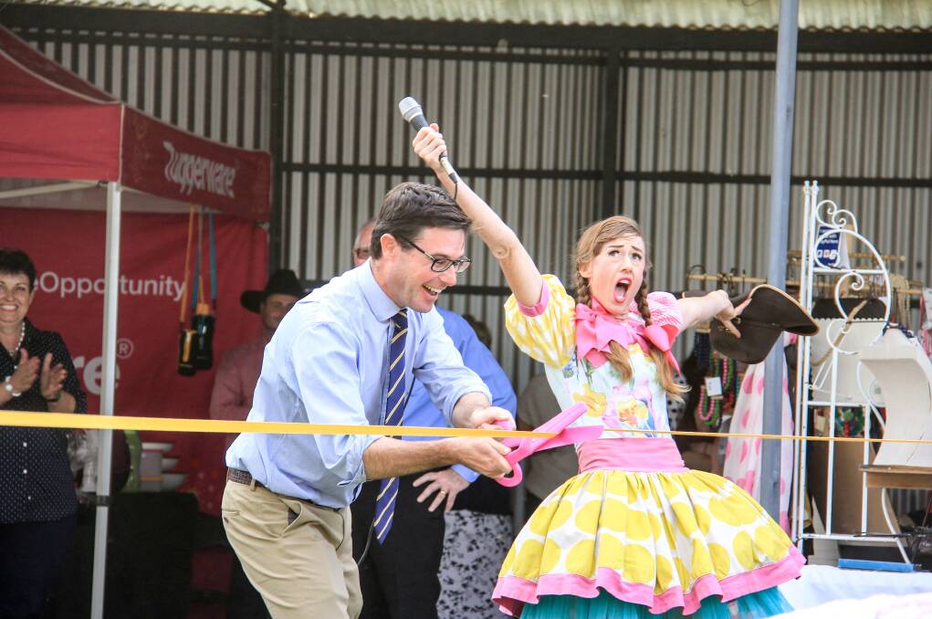 Agriculture and Water Minister David Littleproud cuts the ribbon to open the Dirranbandi, Qld, show with the help of The Crack Up Sisters. Photo Lucy Kinbacher.