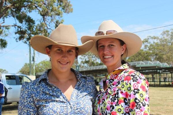 Tamika Spann, Rosevale, and Alexis Hindmarsh, Eidsvold, show the youngsters how judging is done.
