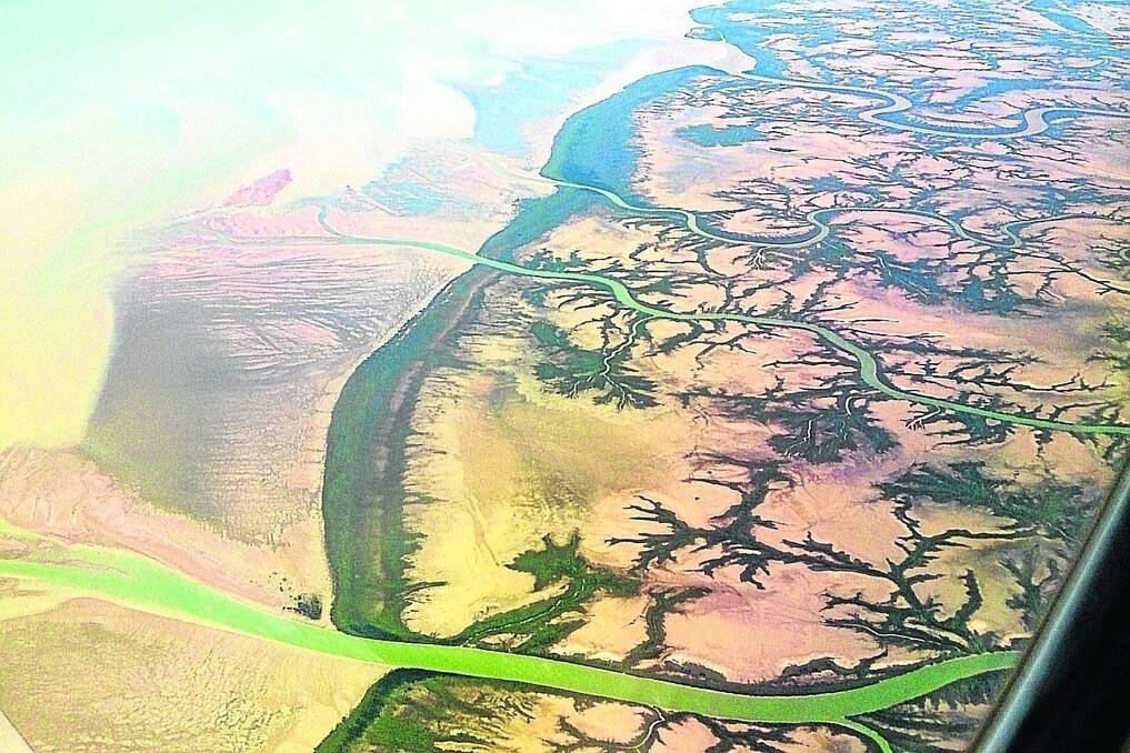 Fresh river water mixes with the muddy banks of the Gulf of Carpentaria coastline.