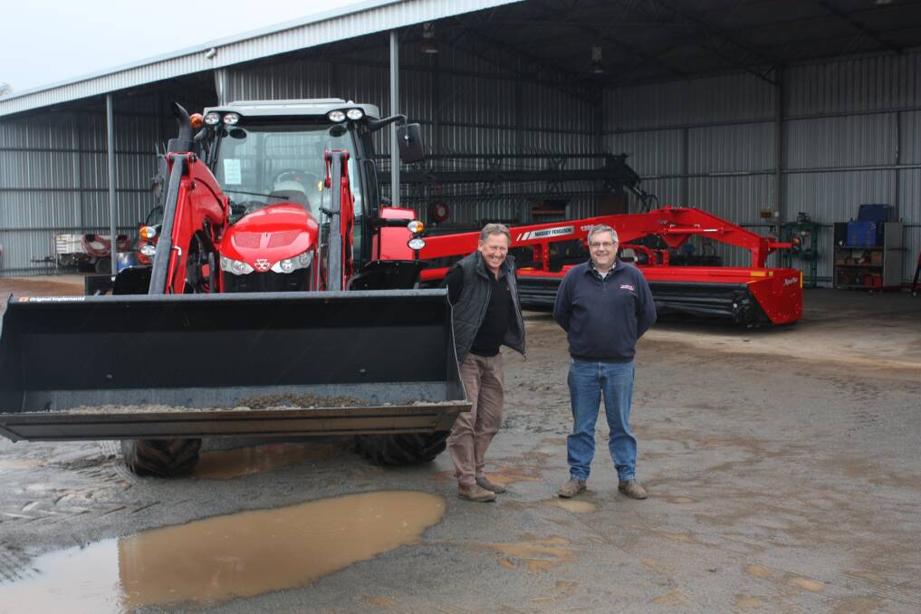 PH Kerr dealer principal Brian Kerr (left) and parts manager Wayne Munyard ‘shed’ the hay combo as season-winning rain falls last week. This combo comprises a Massey Ferguson 7600 Series tractor, a Massey Ferguson loader bucket and a Massey Ferguson 1300 Series mower-conditioner. "We've got ready for immediate delivery," Brian said.     