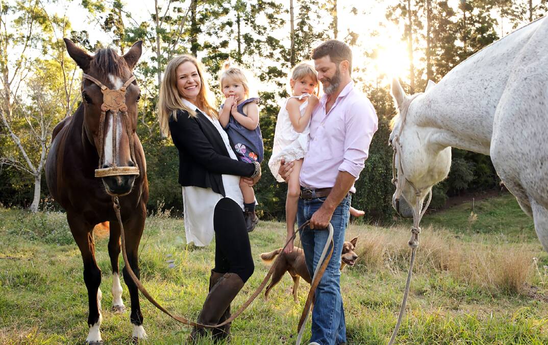 GLOBETROTTING: At home in Maleny with their horses, Kate and Steven Pilcher with daughters Finn and Birdie. 