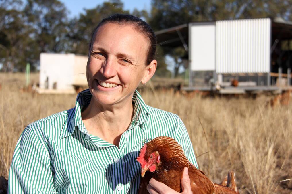 Megan Mackay and one of their pasture fed chickens. 