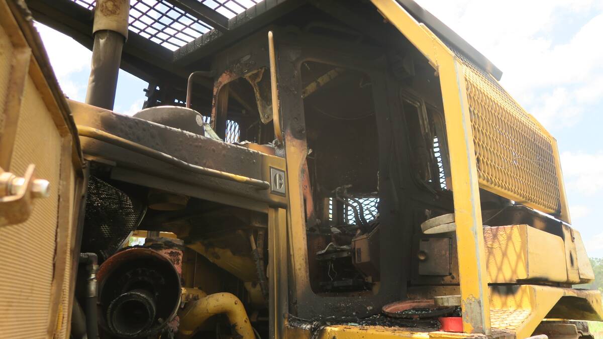 The burnt dozer on their property after the ABC story aired. 