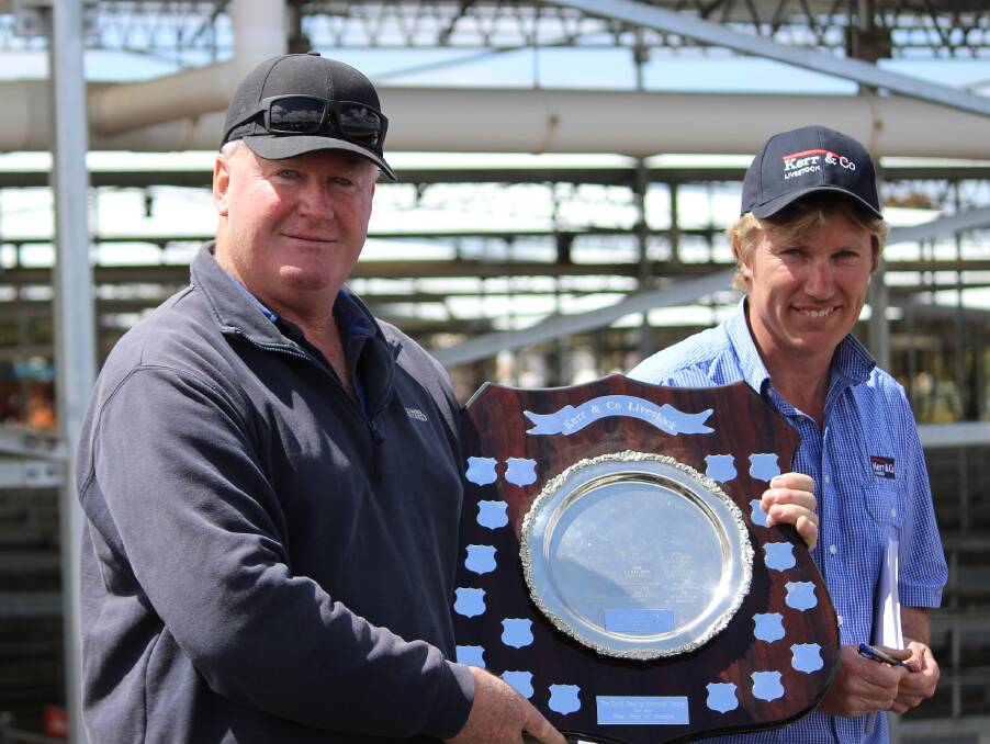 David Roache proudly displays the David Powling Memorial Shield awarded to him for the best presented pen in the annual Kerr & Co Livestock spring sale. Mr Roach is pictured with Kerr & Co's, Shaun Mansbridge. 