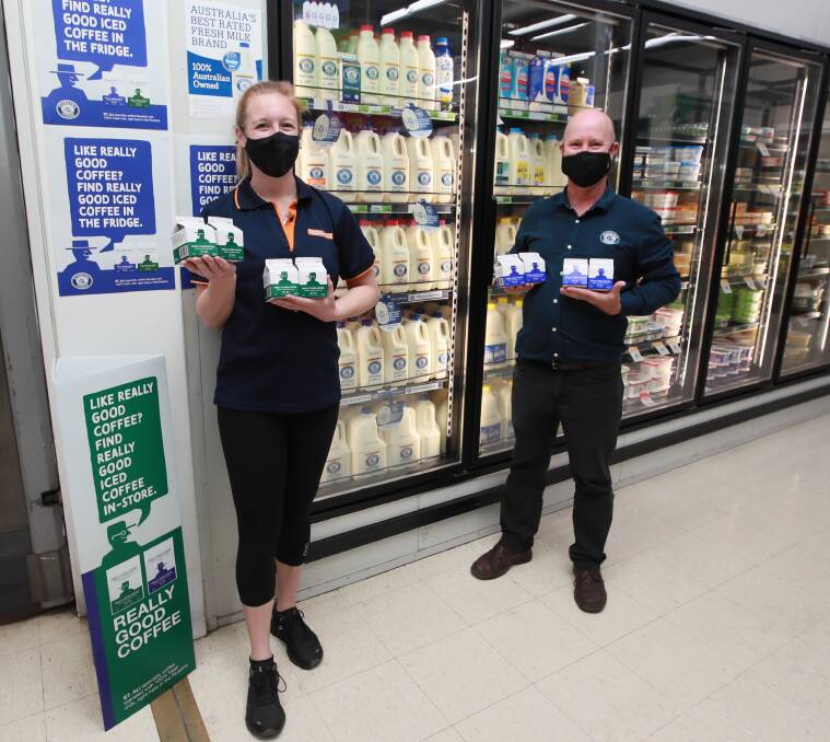 NEW DRINK: Foodworks Lake Albert store manager Bailey Lucas and Riverina Fresh sales manager Jason Brett stack the chill cabinets with new iced drink, Really Good Coffee. Picture: Les Smith