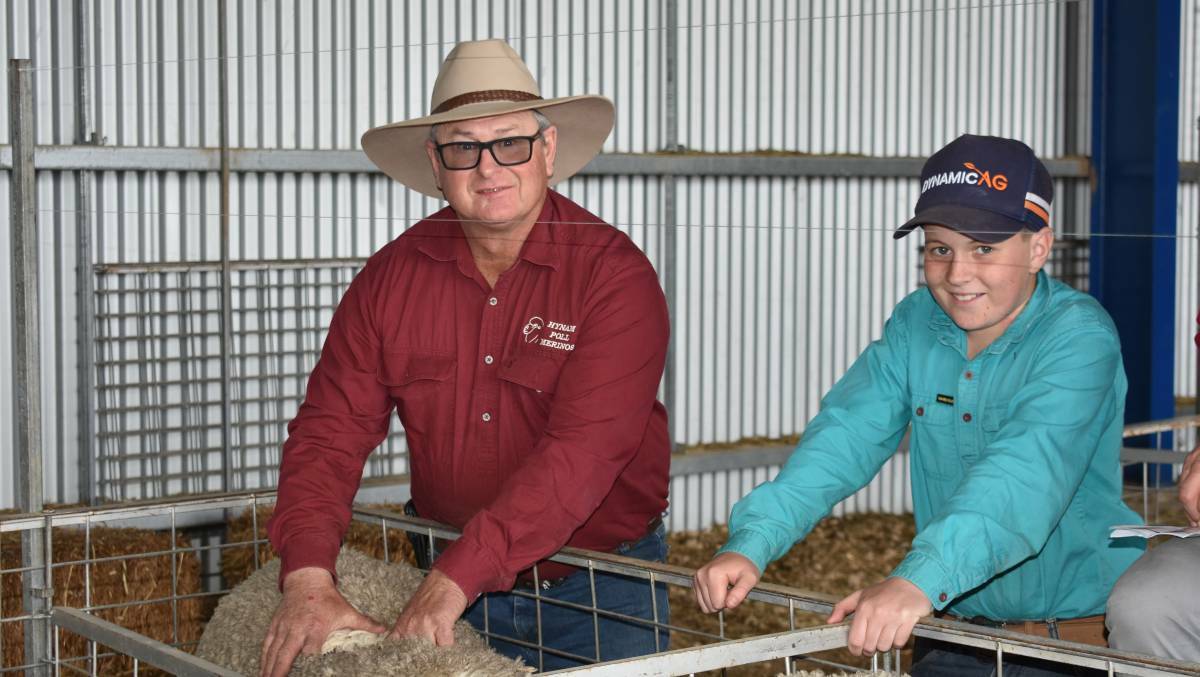 Twelve-year old Lachlan O'Brien with Hynam Poll Merinos principal Kevin Hynam at the Hynam stud sale. Picture: Andrew Miller.