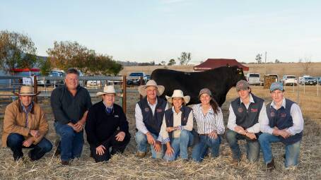 With the top-priced bull are Dave Gibson, World Wide Sires Australia, John Hurley, Kiah Maroo Angus, Toobeah, auctioneer Mark Duffy, Ben and Wendy Mayne, Texas Angus, with their children Rosie, Will and Lachlan.