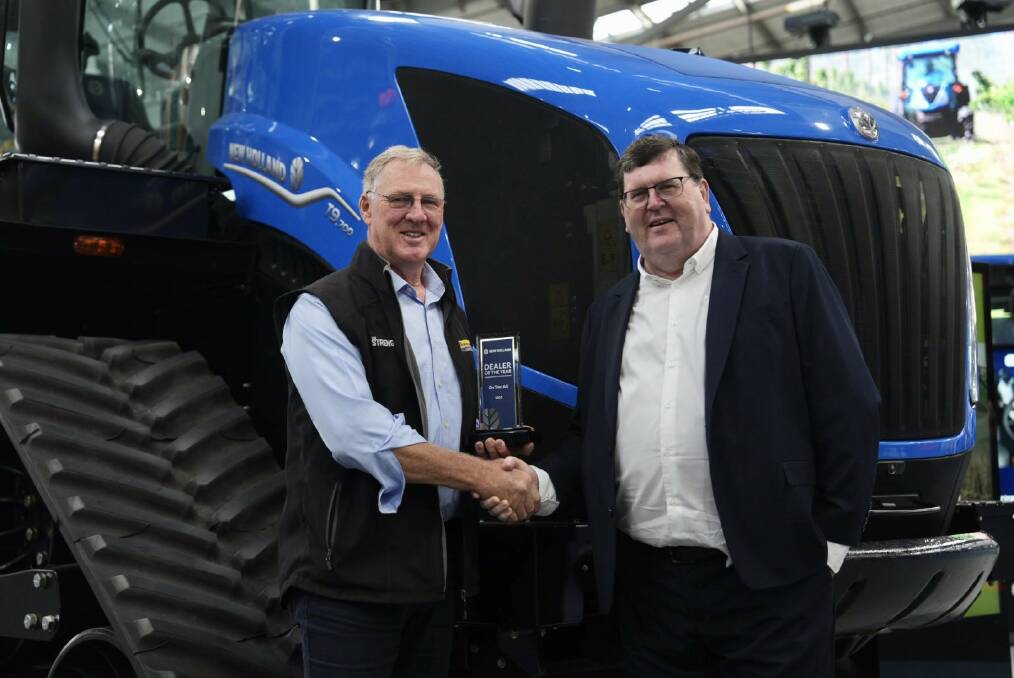 On-Trac Ag director Peter Russell receiving the New Holland Dealer of the Year award for three or more branches from CNH CBU3 operations manager Bruce Healy. Picture supplied