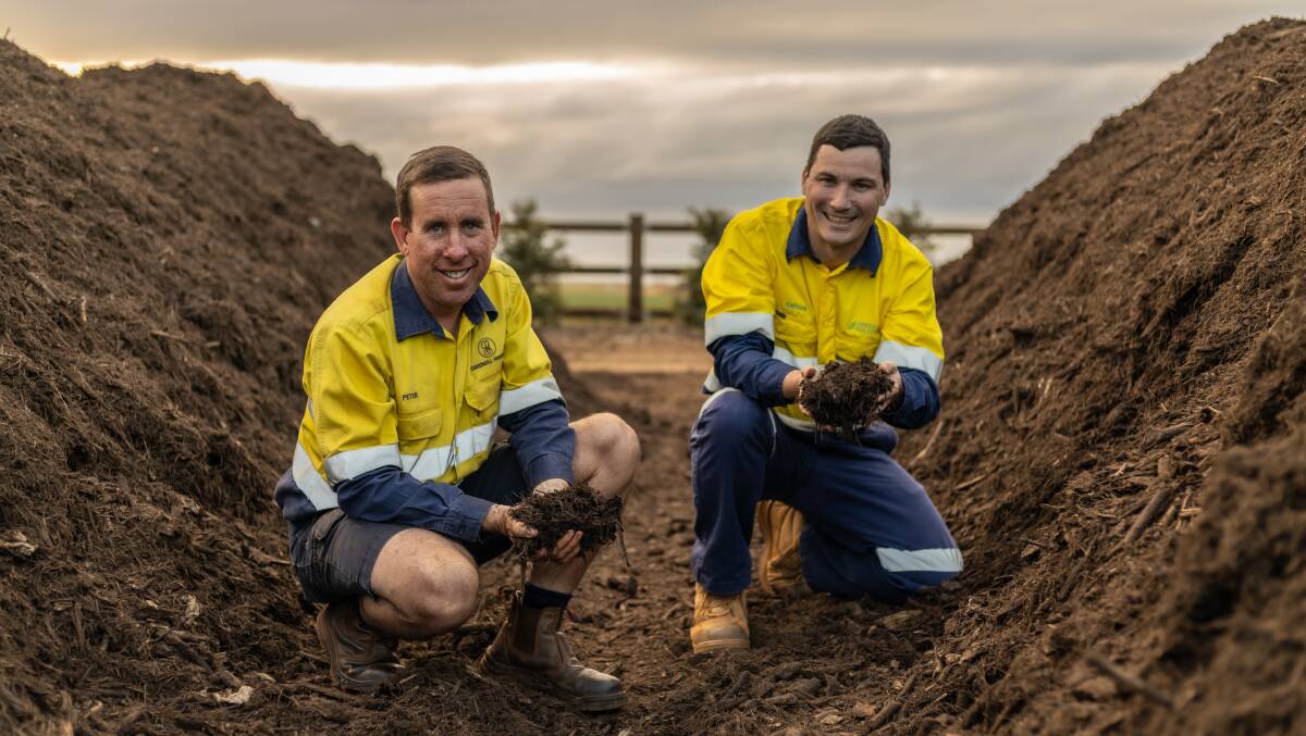 Greensill Farming managing director Peter Greensill with Green Solutions Wide Bay general manager Nathan Freeman with a mound a compost. Picture supplied