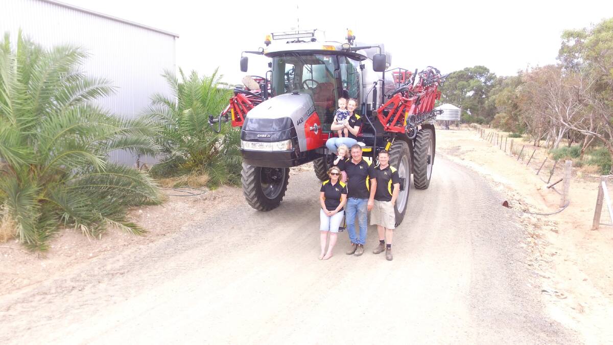 The Krieg family with the Case IH special edition anniversary Patriot sprayer. Clockwise from top, Caitlin, Josh, Robin and Robyn, and Caitlin and Josh’s children Ellie and Noah.