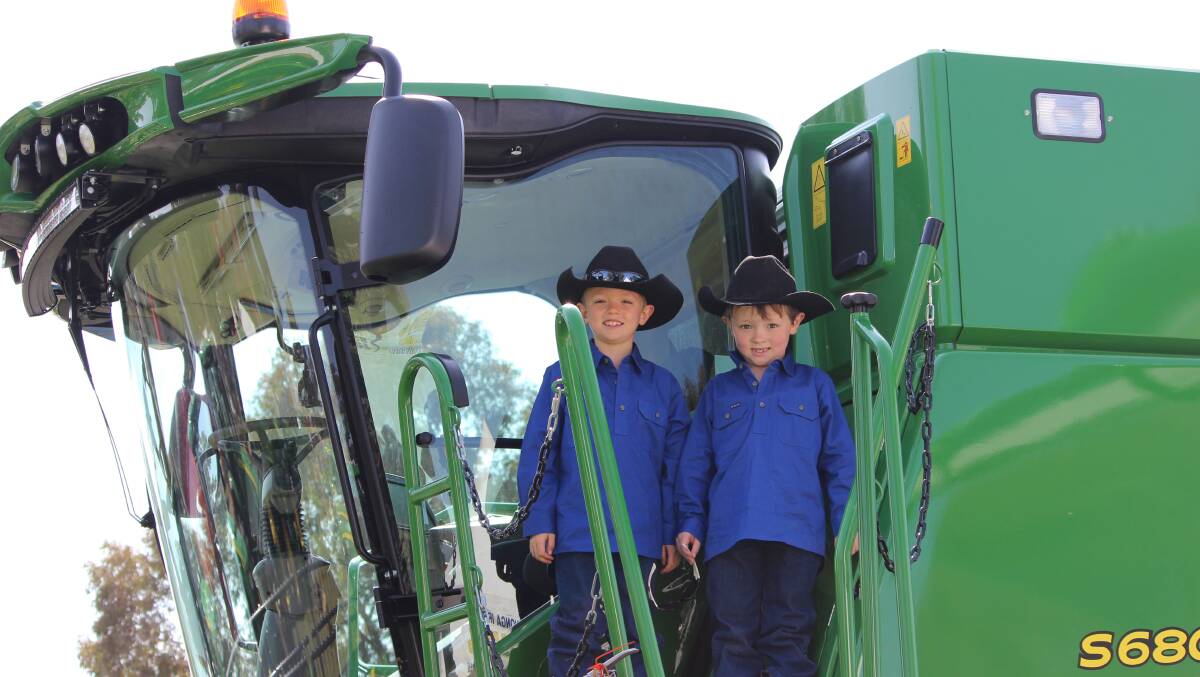 Toby and Lochie Roots, "Truro" Adelong, check out the John Deere S680 S-Series header on display at the Hutcheon and Pearce site at the Henty Machinery Field Days.