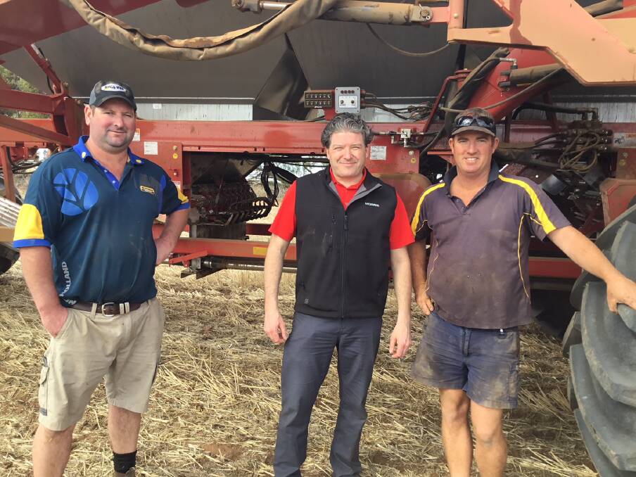 ON TOUR: Justin Ward, of Belle-Vue Trading and Morris Industries, chief executive officer, Ben Voss examine a Morris 9550 air cart with Victorian grower Nathan Williams, during the Morris group’s recent tour across Australia.