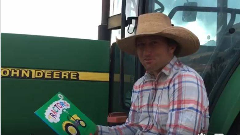 Croppa Creek farmer Ken Barnett reads Tractors by Catherine Foreman to kids as part of the Warialda Public School social media reading program.