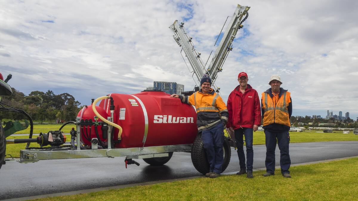 Victoria Racing Club employees Jake Myles and Tim Drysdale, product specialist, Silvan Australia (centre) take delivery of a custom trailed turf sprayer at Flemington Racetrack.