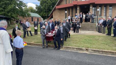 Merino breeders formed a guard of honour as the casket left the church.