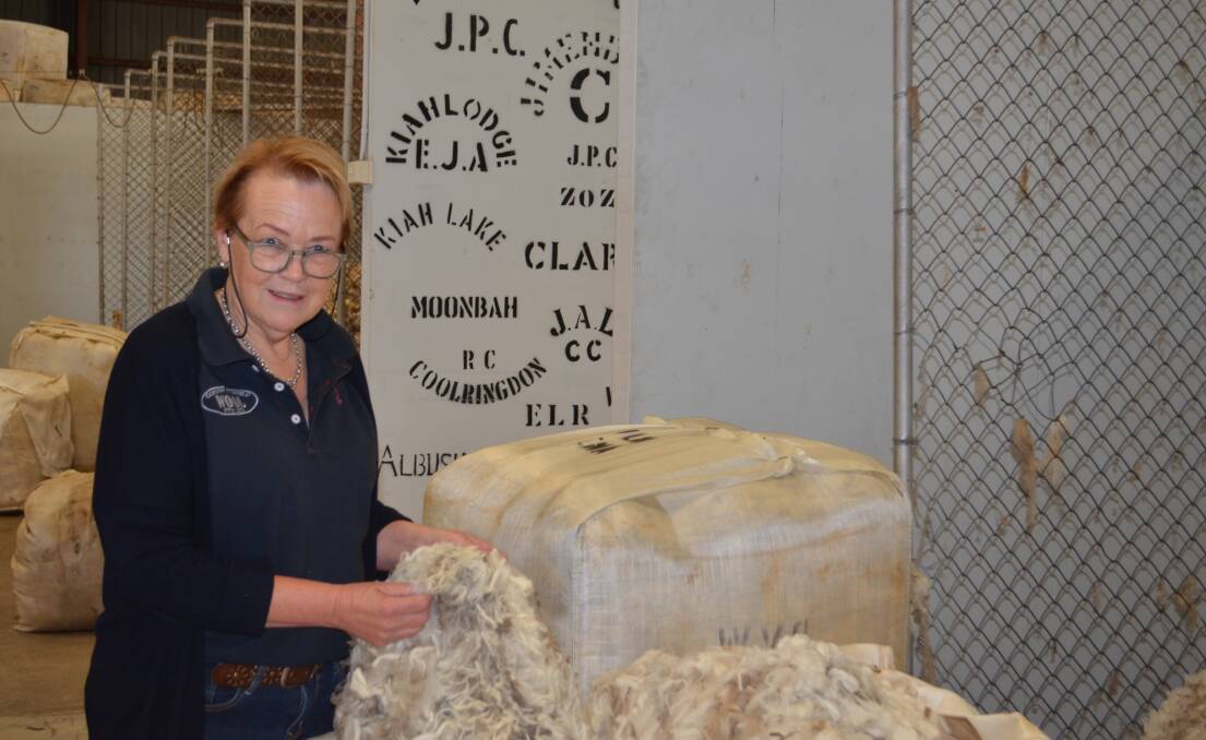 Vicki Flynn getting her hands into a Merino fleece in the Gordon Litchfield Wool woolstore in Cooma..