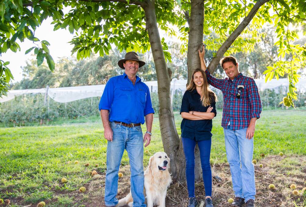 Organic converts Ian, Hannah and Rob Cathels at Ardrossan Orchards, Batlow, and Woody the dog.