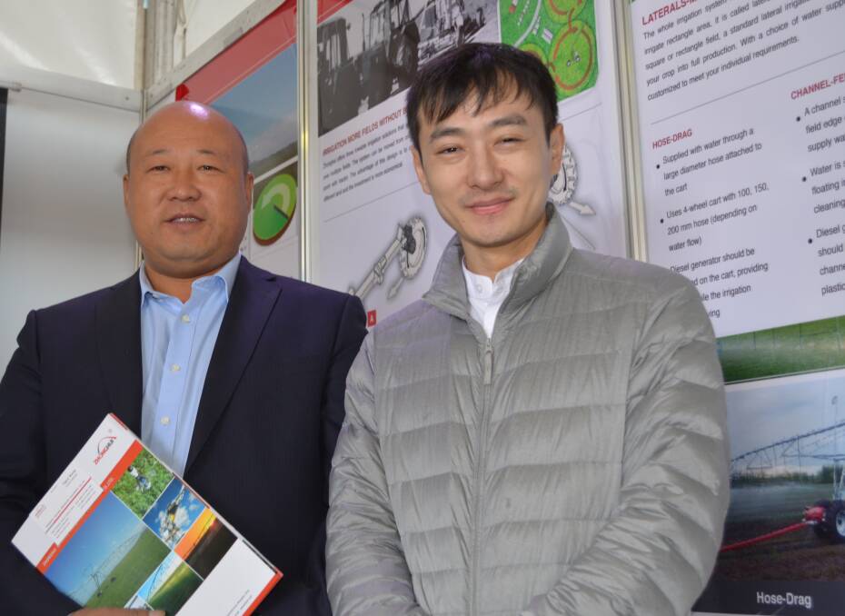 Zonghui Irrigation Equipment Company general manager, Yiguo Wang, with his interpreter at AgQuip, promoting centre pivot and lateral move irrigators built by the company in Dalian Province and Inner Mongolia and sold to farms in Canada, Saudi Arabia, South America and Australia.
