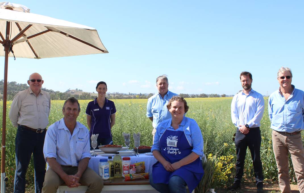 Marking the food donation milestone (standing) Foodbank NSW and ACT agencies team leader, Gerry Andersen, with Foodbank Australia national agriculture program manager, Jacqui Payne; Manildra mill manager John Brunner; Foodbank NSW and ACT agencies team leader, Adam Loftus, and MSM Milling director, Bob Mac Smith with (seated) MSM Milling director, Peter Mac Smith and Molong District Baptist Church Pantry representative, Julie Spencer, in a canola crop from which oil for the Foodbank program will be pressed in November.