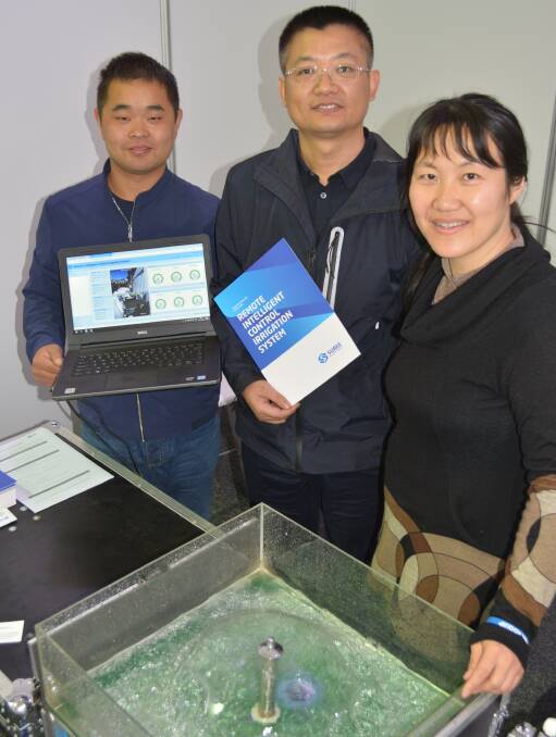 Chinese exhibitors from the Suree Intelligent Technology Company in Dongying City, Jianfeng Wang, general manager, Chunhe Li, and Australian-based representative, Cleo Wang, demonstrate a remote irrigation management system at AgQuip field days.