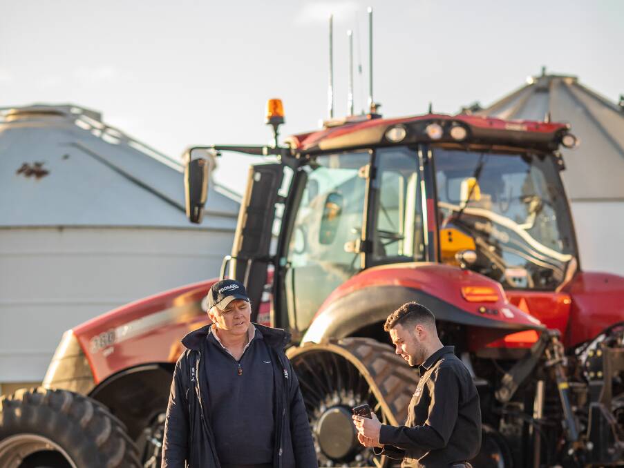 Riverina farmer, Andrew Dumeresq, with with Zetifi chief technology officer, Ben Letchford, and a ZetiRover hotspot relay technology mounted on the tractor cab. Picture: Zetifi