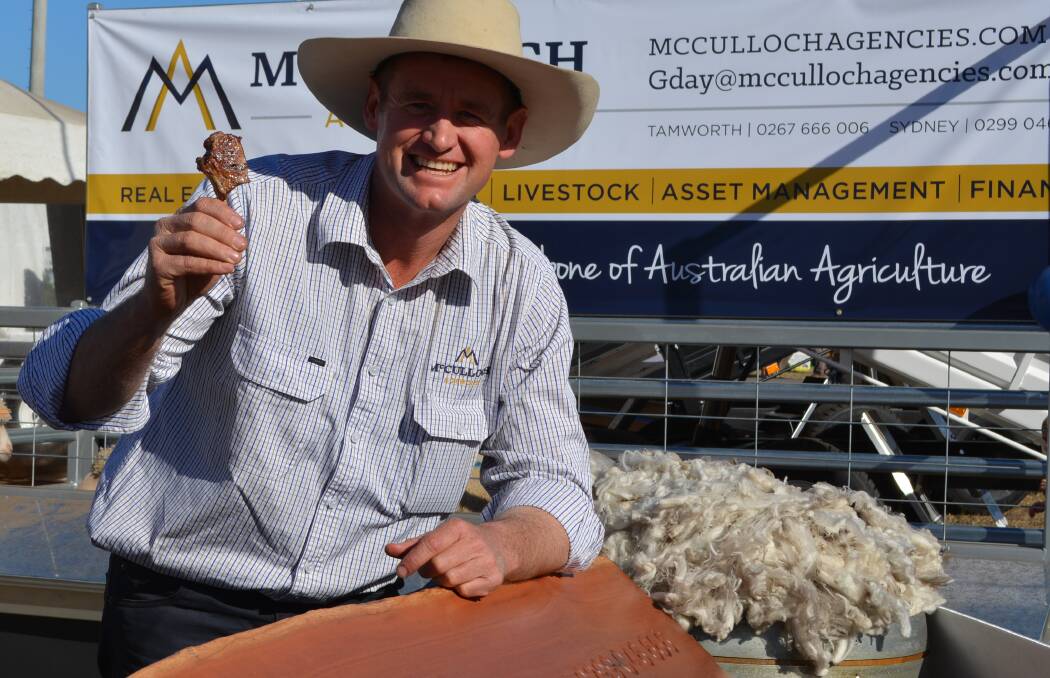 Selling agent, Daniel McCulloch, shares his enthusiasm for the lamb industry with a cutlet salute to visitors at AgQuip.