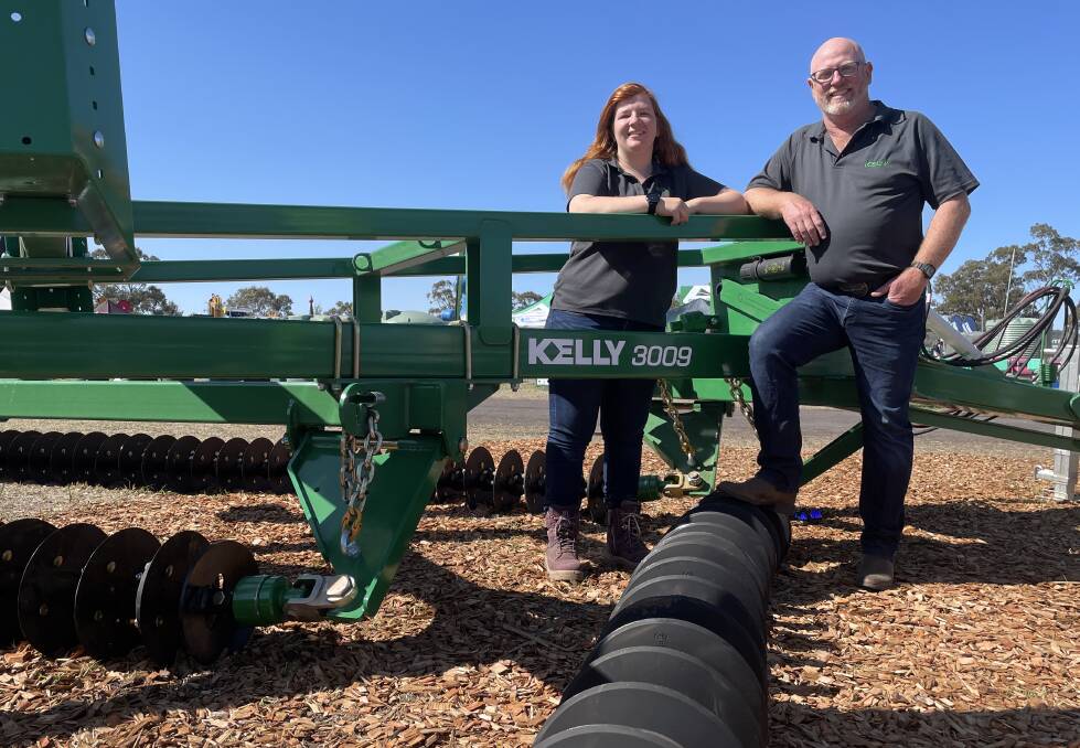 Kelly Tillage's Australian market liaison officer, Hayley Forbes, with product specialist, Cavin Osborn, and a nine metre Kelly Diamond Harrow on show at AgQuip field days in NSW. Photo Andrew Marshall.
