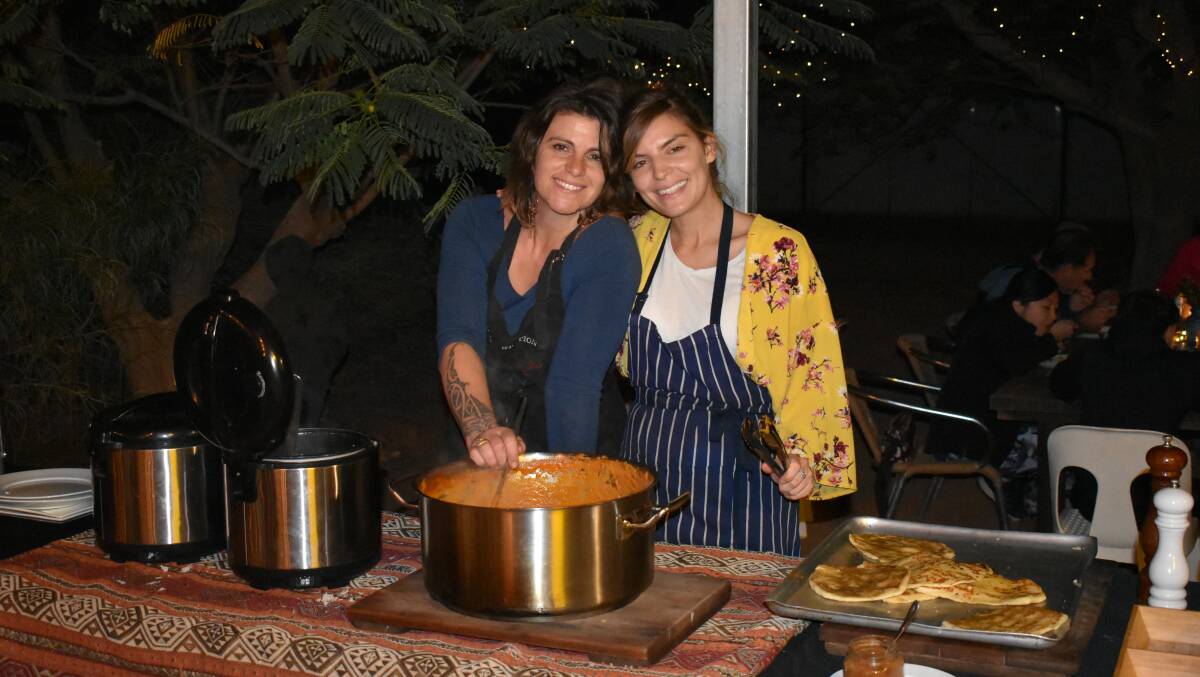 Station cook Courtenay Stickels and assistant Amina Chioua, from Northern Italy, serving up a butter chicken feast.