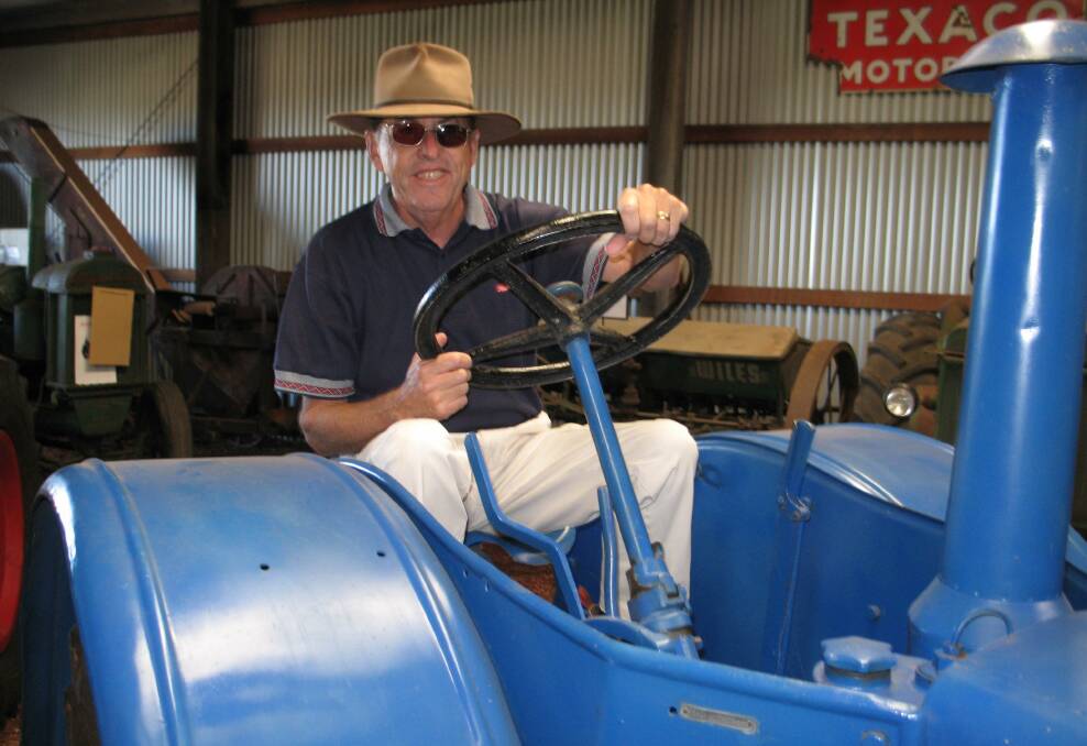 Ken Wilson back at the wheel of the Lanz Bulldog he used to drive on the family farm at Cunderdin. He unexpectedly discovered the restored tractor at the Dardanup Heritage Park during an interview about the famous museum.