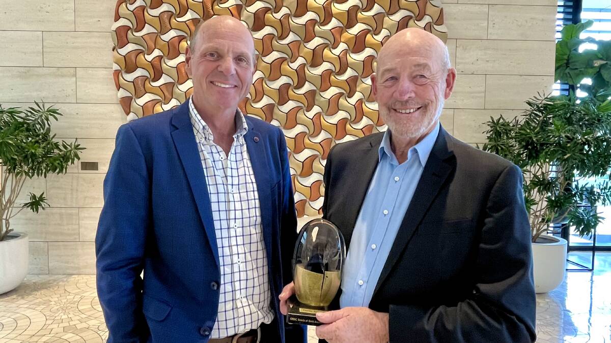 GRDC chairman John Woods (left), presents Terry Enright with the Seed of Gold award at the GRDC update in Perth on Monday morning.