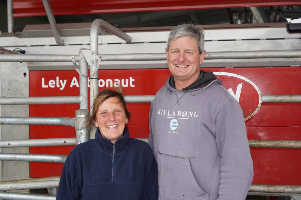 Leesa and Grant Williams in front of one of their newly installed robots on their farm. The robots have replaced a rotary dairy.