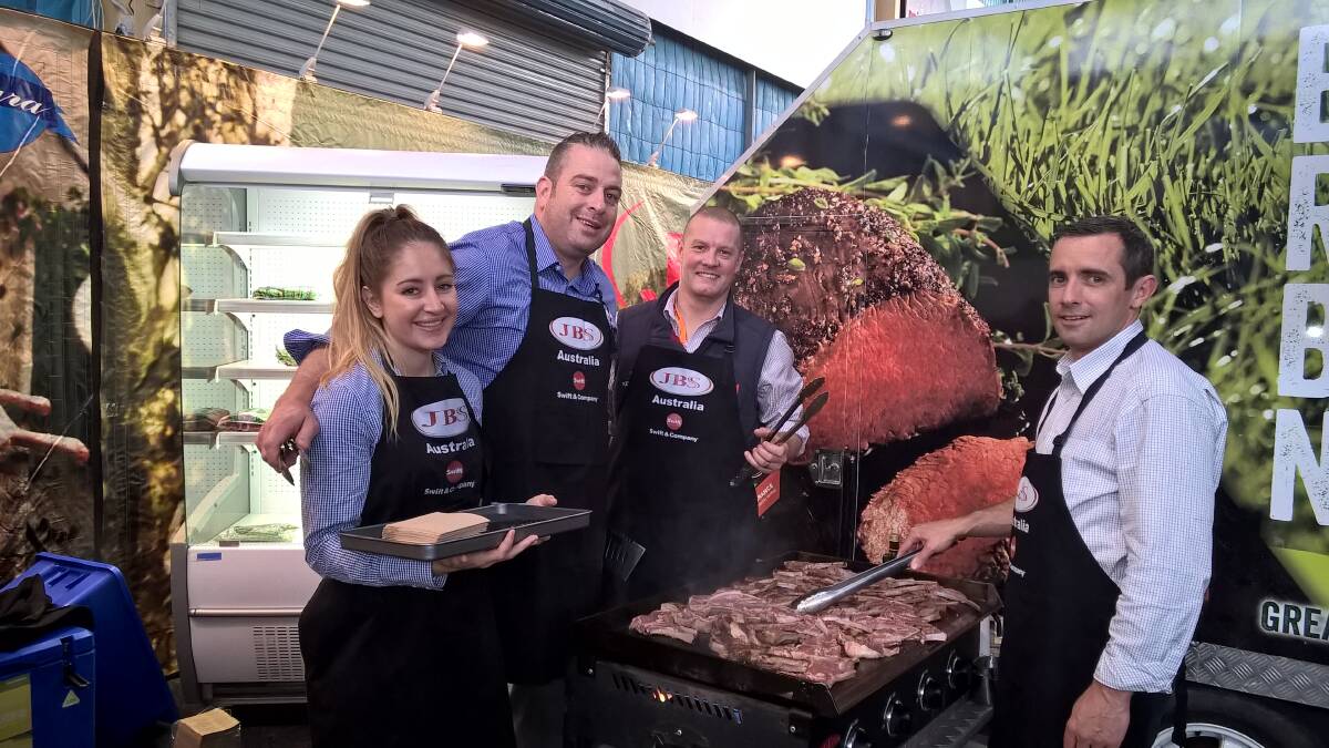 JBS staff Laura Wishart, Brendon Geary and Guy Chisnall with Meat and Livestock Australia's Sam Burke at an on-farm producer education day, with the company's mobile boning and cool room and barbecue.