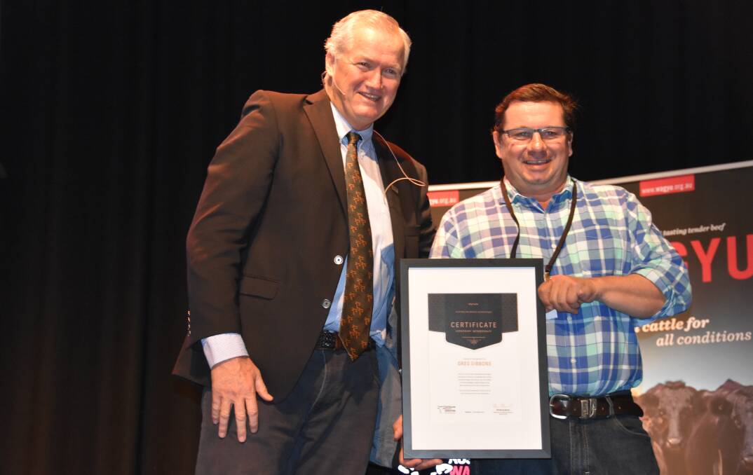 AACo's feedlot boss Greg Gibbons is presented with life membership of the Australian Wagyu Association by president Peter Gilmour.