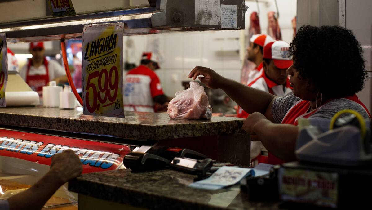 A meat purchase is made at a public market in Sao Paulo, Brazil.   Photo: Victor Moriyama/Getty Images